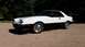 1985 Ford Escort - This two-tone coupe features pop-up headlights and a sporty profile, distinct from the claimed 1985 Ford Escort.