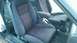 1985 Ford Escort - Interior view of a 1985 Ford Escort, highlighting the cloth seats and manual shifter.
