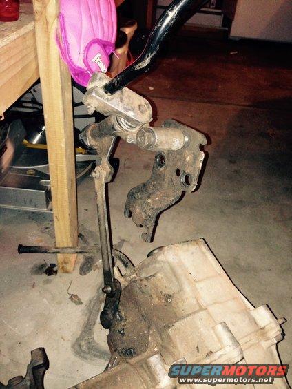 Transfer case and linkage assembly with a pink object attached to a metal bar