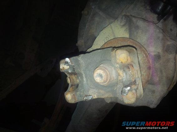 Close-up of a driveshaft U-joint connection with rust and wear