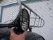 1964 Volkswagen Beetle - A close-up shows a hand adjusting an off-road light attached to a vehicle's roof rack.