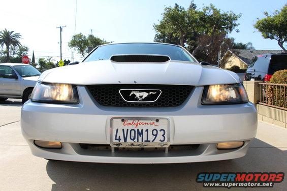 Silver 2002 Ford Mustang front view, California license plate 4VQM193, hood scoop, headlights on