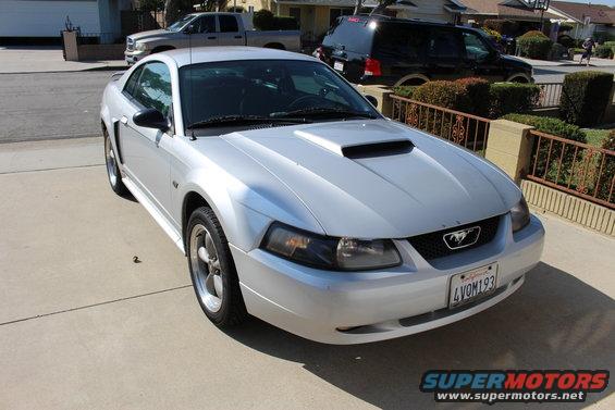 Silver 2002 Ford Mustang coupe with hood scoop and license plate 4VOM193