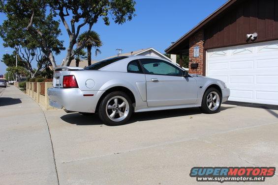 Silver 2002 Ford Mustang coupe parked in driveway