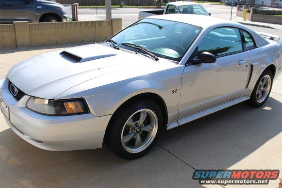 Silver 2002 Ford Mustang GT coupe parked on concrete, front 3/4 view