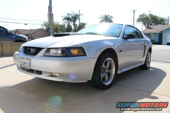 Silver 2002 Ford Mustang parked on a driveway, front 3/4 view