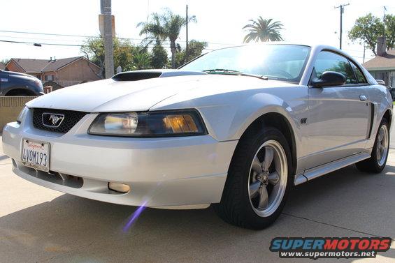 Silver 2002 Ford Mustang with a hood scoop and GT badging