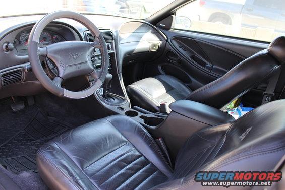 2002 Ford Mustang interior showing leather seats, dashboard, and steering wheel