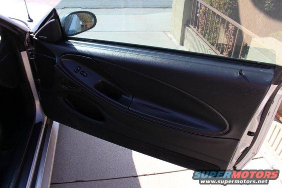 2002 Ford Mustang interior door panel with window controls and black upholstery