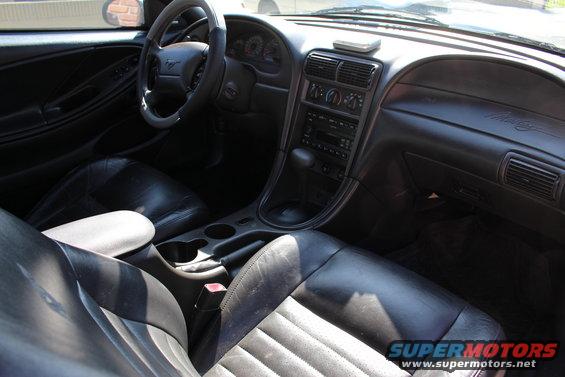 2002 Ford Mustang interior showing dashboard, steering wheel, and seats