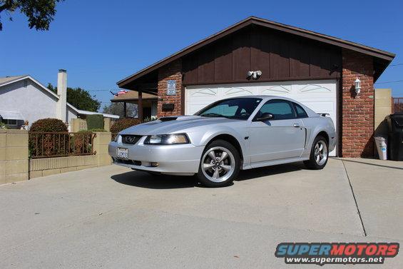 Silver 2002 Ford Mustang coupe parked in driveway
