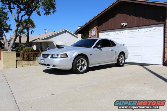 Silver 2002 Ford Mustang coupe parked in driveway