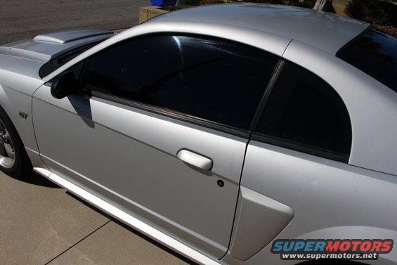 Side view of a silver 2002 Ford Mustang with tinted windows