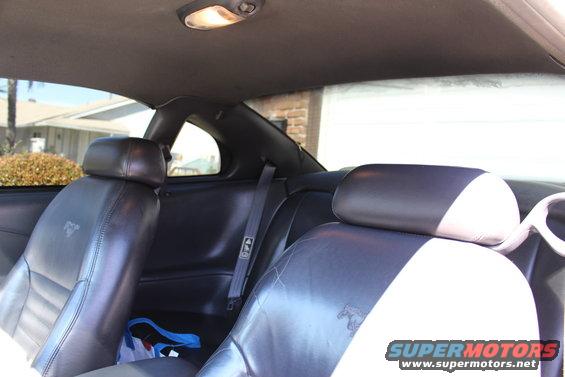 Interior view of a 2002 Ford Mustang showing black leather seats with embossed horse logos