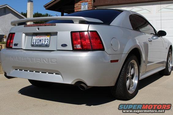 Silver 2002 Ford Mustang GT rear quarter view, showing spoiler, GT badge, and California license plate 4VOM193