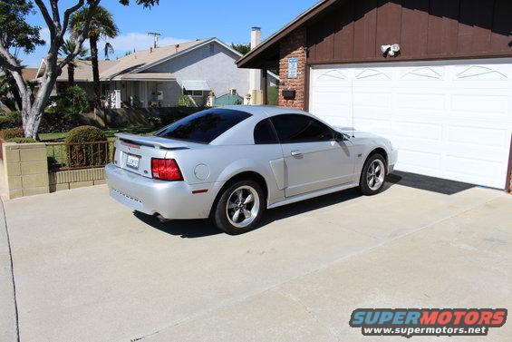 Silver 2002 Ford Mustang coupe parked in driveway