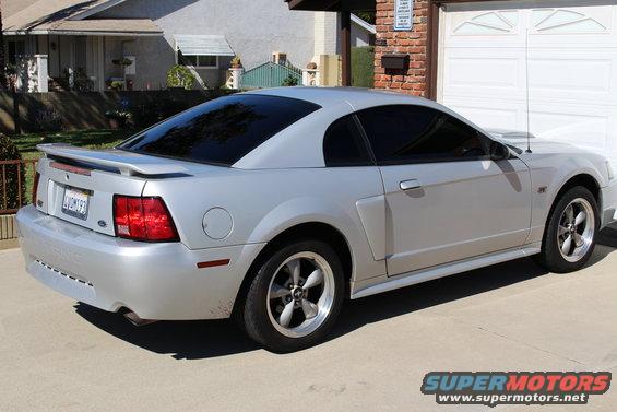 Silver 2002 Ford Mustang coupe parked in driveway