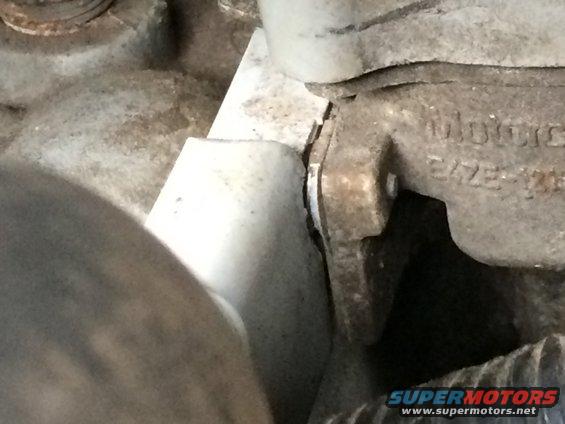 Close-up of a metal engine component with visible text and dirt