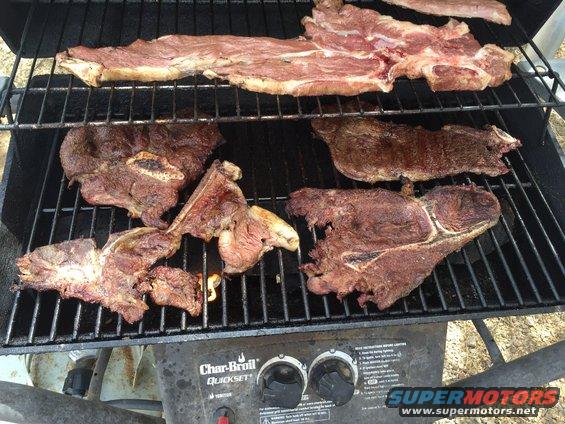 Steaks cooking on a Char-Broil grill