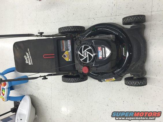 Black lawn mower with "Dust Blocker" bag and "Platinum 720" engine