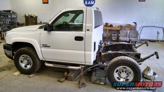 White pickup truck chassis, side view. "Duramax" badge visible