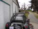 1964 Volkswagen Beetle - Rear view of a black 1964 Volkswagen Beetle, a roof rack and a "Volks Cafe" license plate.