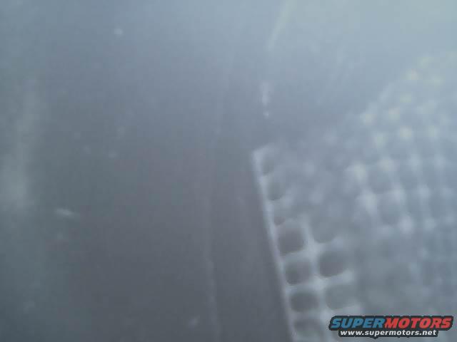 close-up of exhaust pipe with Supermotors.net logo