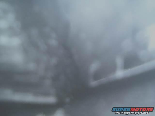 Exhaust pipe, blurry, dark gray, part of a vehicle