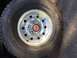 1994 Ford Bronco - Close-up of a chrome wheel with a red Ford emblem and tire, likely from a truck or SUV.