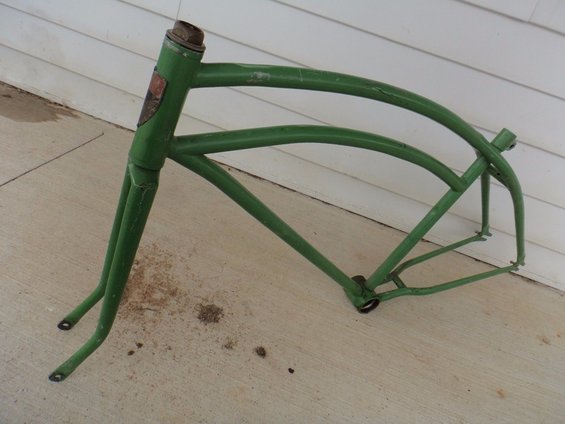 Green bicycle frame with a badge on the head tube