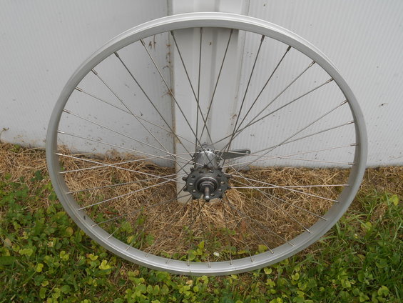 Silver bicycle wheel with freewheel hub