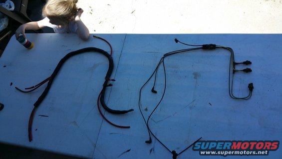 Two sets of black vacuum lines with red wire accents laid out on a white table