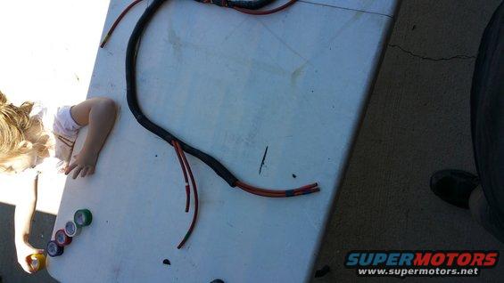 Wiring harness on a table with a child's arm