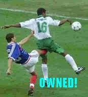 Soccer players in action, one kicking the ball