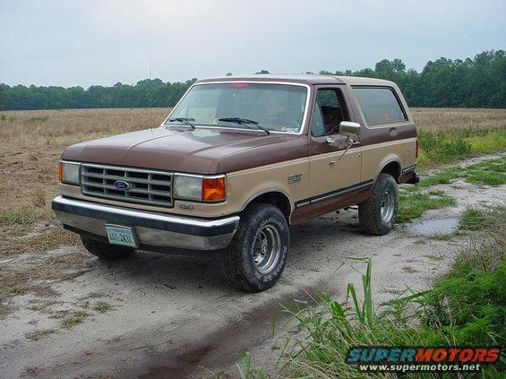 Two-tone brown 1987 Ford Bronco parked on a dirt road