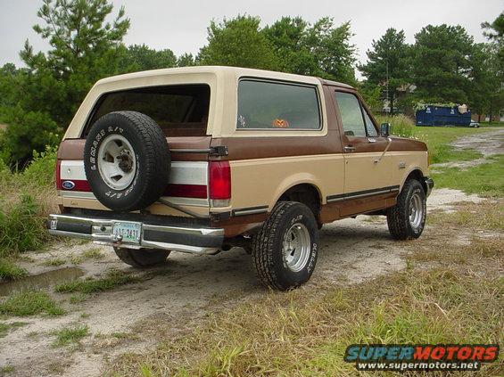 1987 Ford Bronco rear view, two-tone brown and tan, spare tire on door