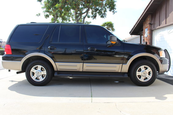 Black 2003 Ford Expedition parked on concrete driveway, side view
