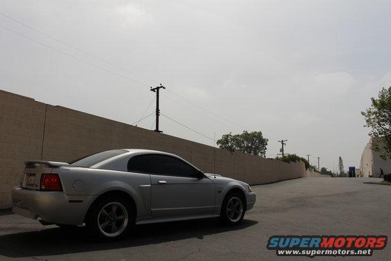 Silver 2002 Ford Mustang parked on asphalt, side view