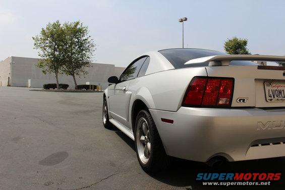 Silver 2002 Ford Mustang GT rear quarter view, showing GT badge and spoiler