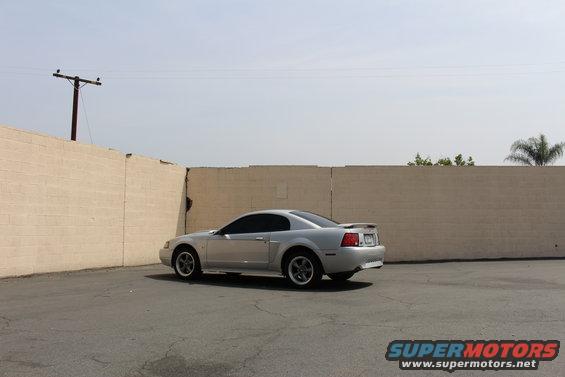 Silver 2002 Ford Mustang parked on asphalt, side view