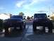 2004 Jeep Grand Cherokee - Two Jeep SUVs, a Grand Cherokee and a Wrangler, are parked in a driveway under a blue sky.