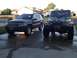 2004 Jeep Grand Cherokee - A dark 2004 Jeep Grand Cherokee is parked in a driveway next to a modified Jeep Wrangler.