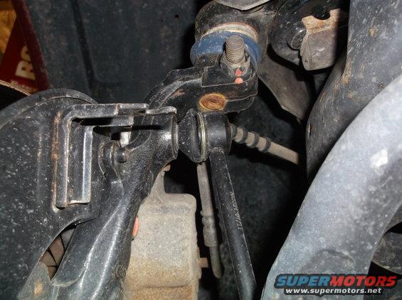 close-up of car's front suspension parts, including ball joint and control arm