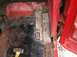 1979 Ford Bronco - This image shows a heavily rusted interior floor pan of a red vehicle, with visible metal patches and welds indicating repairs.