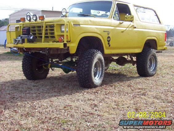 Yellow 1981 Ford Bronco with a winch, bull bar, and lifted suspension