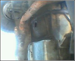 Transmission housing and exhaust pipe, close-up view