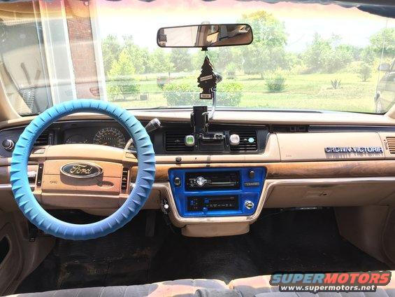 1994 Ford Crown Victoria interior with blue steering wheel cover and wood trim