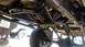 1988 Ford Bronco - Undercarriage view shows custom roll cage and suspension parts on a vehicle. Another vehicle is visible in the background.