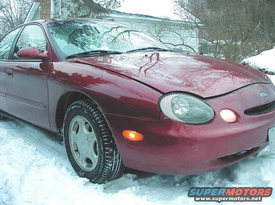 Red 1997 Ford Taurus parked in snow