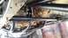 1988 Ford Bronco - This photo shows the undercarriage of a vehicle, highlighting custom roll cage and suspension parts.